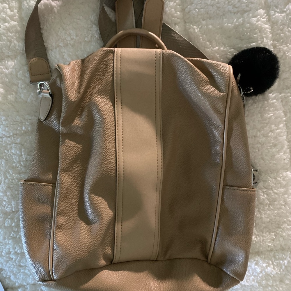 Tan colored vegan backpack.